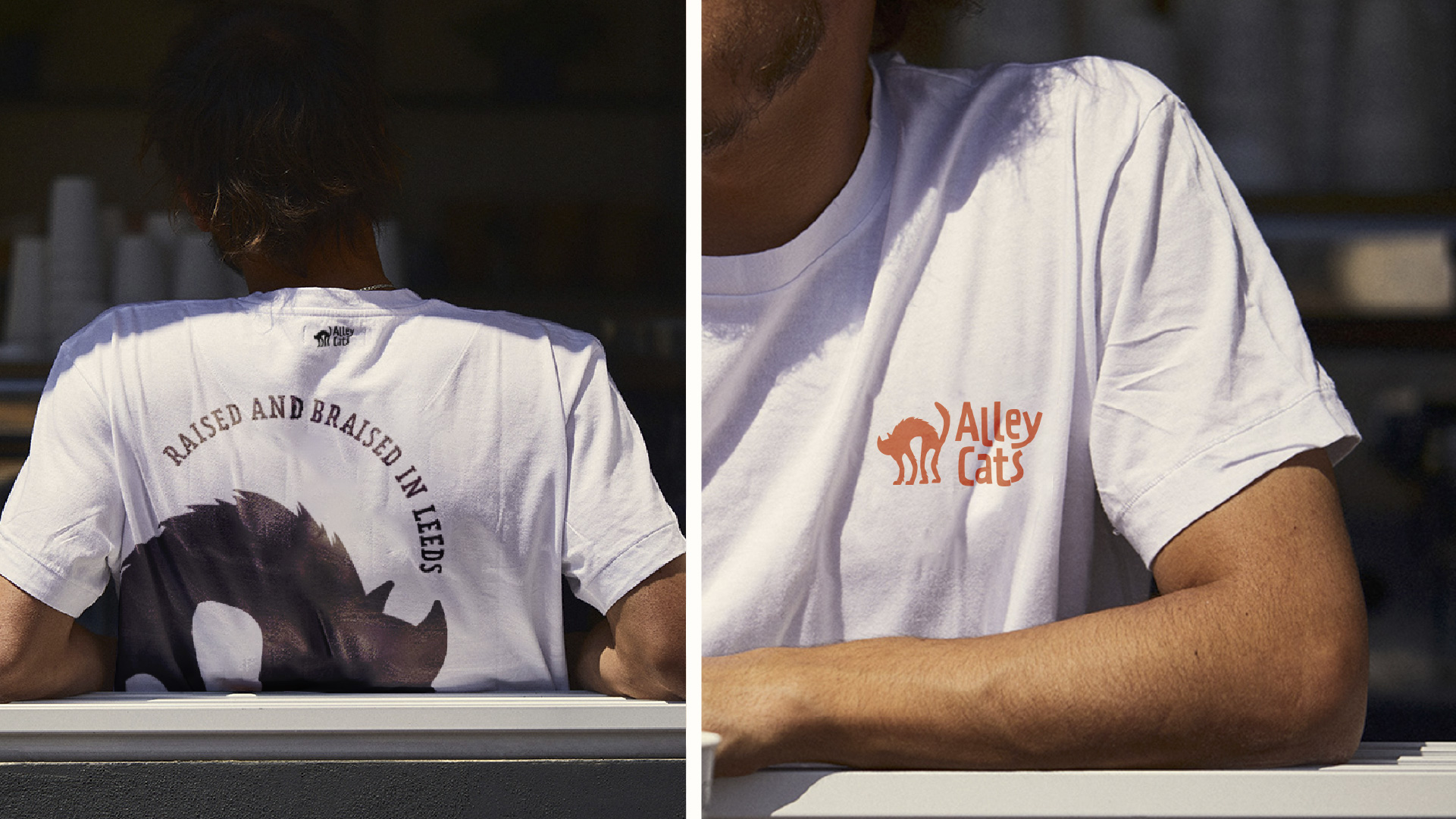 Barista;s leaning with the logo of alley cats printed on both back and front of their white t-shirts