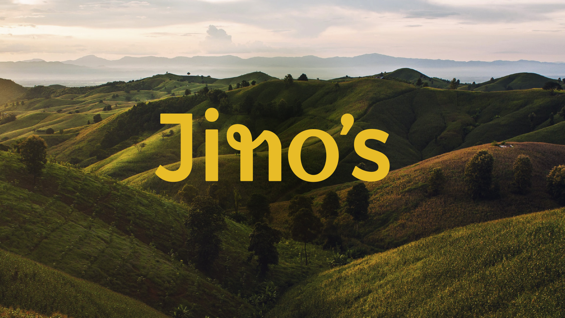 logo of Jino's Thai Café set on an image of the green hills in Northern Thailand.