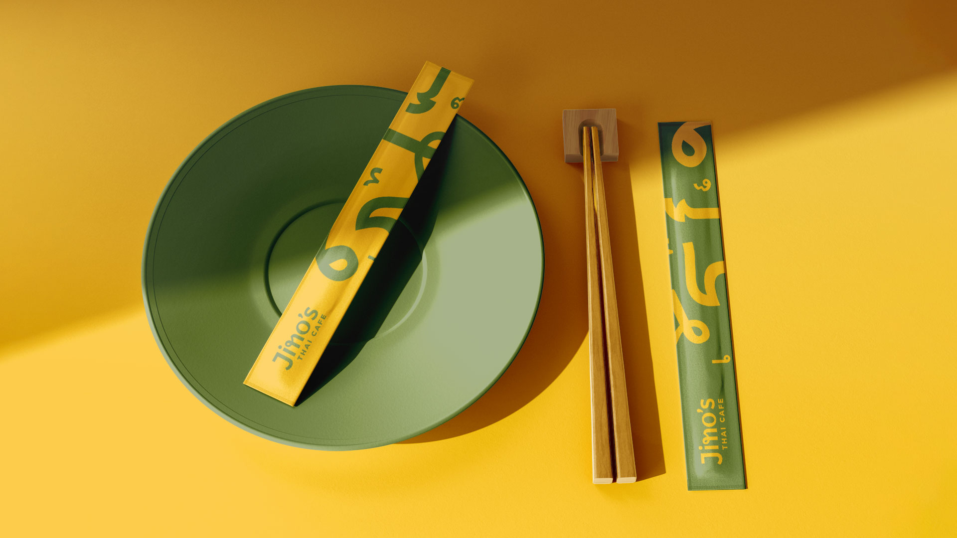 Scene with the two main colours of Jino's thai cafe with branded chop sticks and packaging